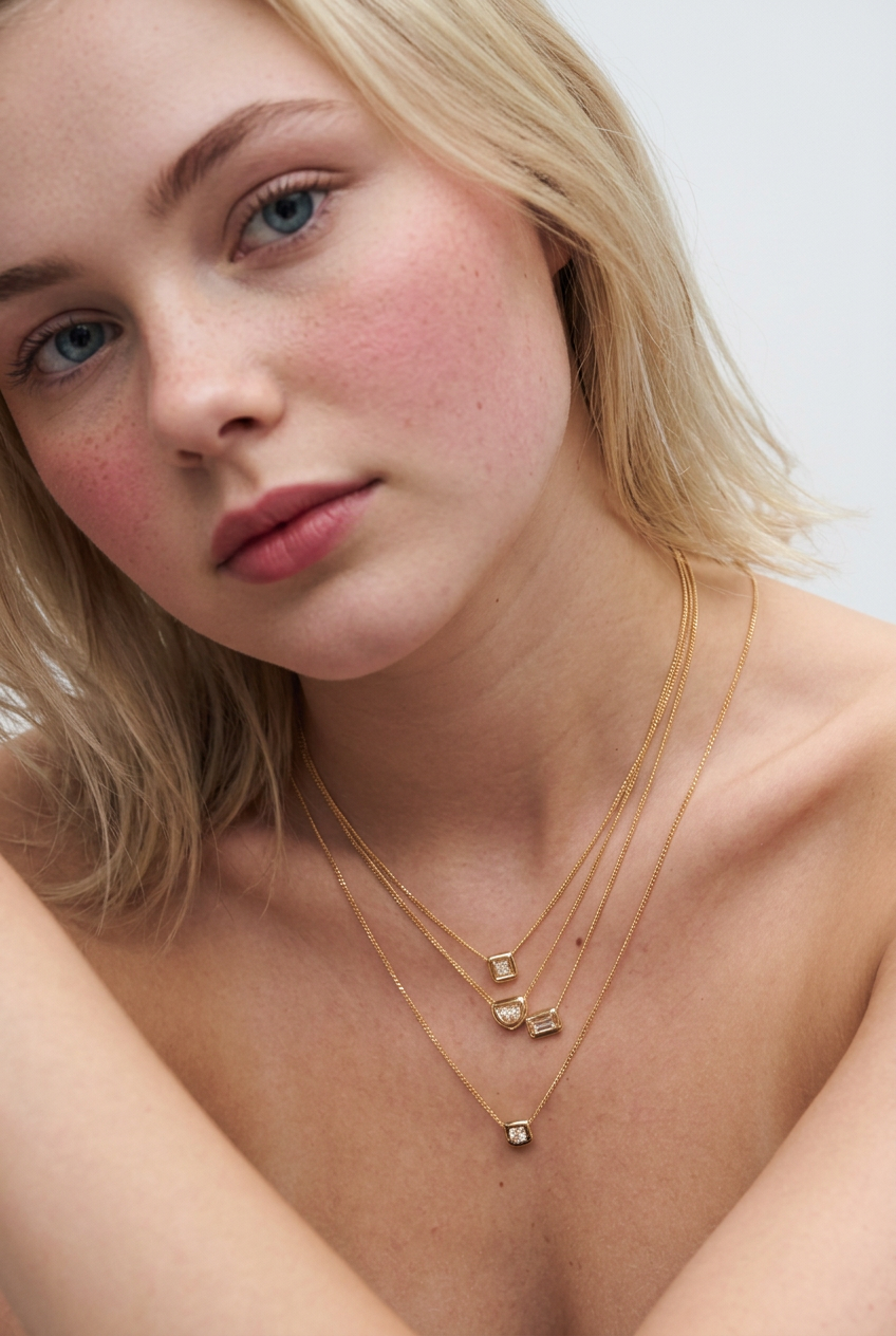 Necklace at Sunshine Diamonds - full model lifestyle image wearing layered diamond necklaces