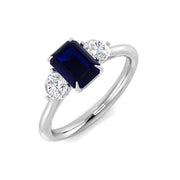 Three Stone Emerald Cut Blue Sapphire Ring with Round Diamond Side Stones in 10K/14K gold and platinum with certified lab-grown or natural diamonds