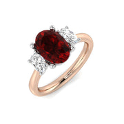 Ruby Three Stone Ring Oval Cut with Diamond Side Stones in 10K/14K gold and platinum with certified lab-grown or natural diamonds