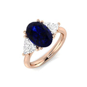 Oval Sapphire Three Stone Ring with Trillion Side Stone Diamonds in 10K/14K gold and platinum with certified lab-grown or natural diamonds