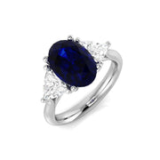 Oval Sapphire Three Stone Ring with Trillion Side Stone Diamonds in 10K/14K gold and platinum with certified lab-grown or natural diamonds